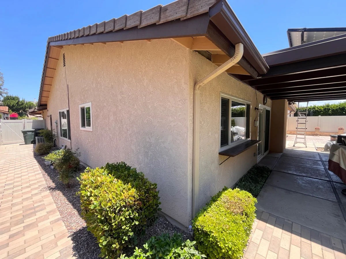 Finished rear stucco wall elevation after AWC resurfacing and integrated-color finish work